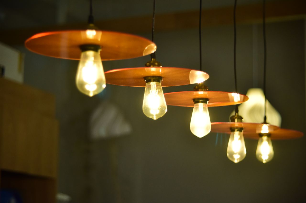Elegant hanging pendant lights with warm glow in a modern indoor setting.