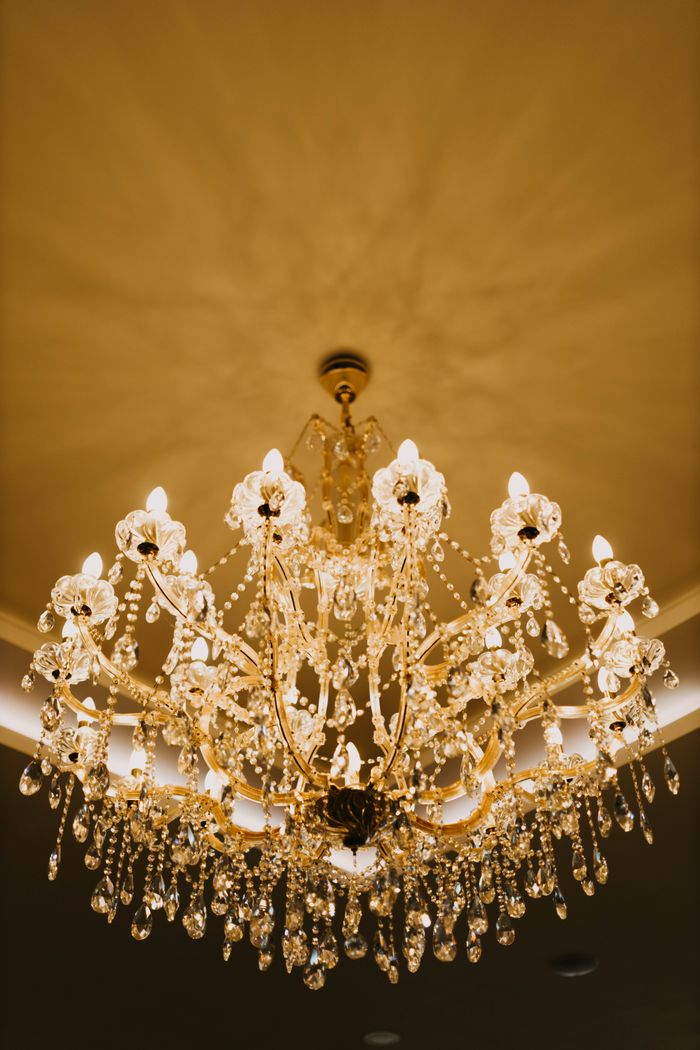 Luxurious crystal chandelier illuminating an elegant room, creating a warm and inviting atmosphere.