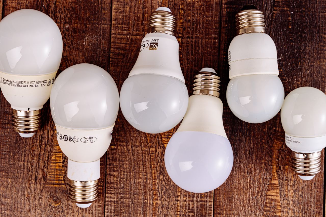 ours-journey LED light bulbs arranged on a wooden surface, showcasing their modern design.